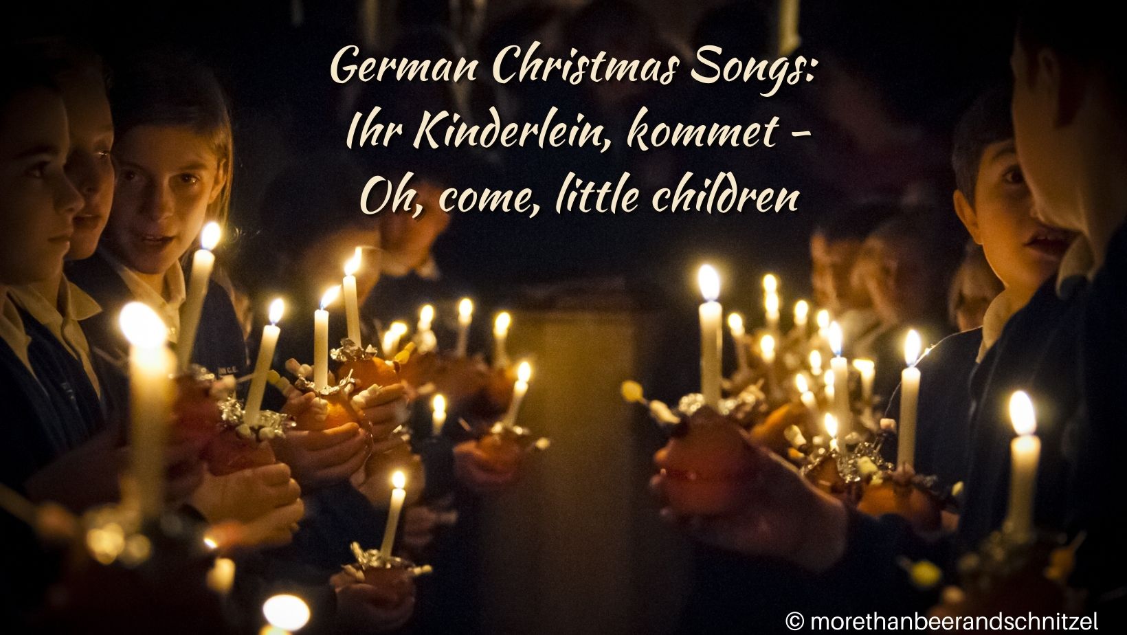 children with candles standing in two rows facing each other, background is dark. text says German christmas songs ihr kinderlein kommet, oh come little children